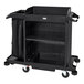 A black Rubbermaid housekeeping cart with wheels and baskets.