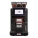 A black and silver LaCimbali S15 espresso machine with a red light and a glass container of coffee beans.