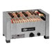 An EmberGlo natural gas countertop charbroiler with kabobs cooking on it.