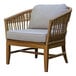 An Outdoor Interiors wicker lounge chair with a cushion.
