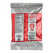 A close up of a red and white Sqwincher QwikStik Zero Fruit Punch drink mix bag.
