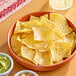 A bowl of Celia's yellow corn tortilla chips on a table.