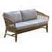 An Outdoor Interiors teak and wicker sofa with white cushions.