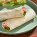 Two Celia's Super Pliable flour tortillas on a plate with salad