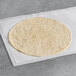A Celia's rosemary herb garlic tortilla on a white surface.