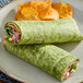 A plate of Celia's Spinach Flour Tortilla with chips.