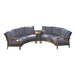 A gray and brown wicker sectional couch with wooden armrests and cushions.