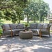 A 4PC conversation set with gray cushions and a table on a stone patio.
