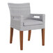 An Outdoor Interiors wicker dining arm chair with grey cushion on wooden legs.