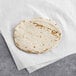 A Celia's flour tortilla on a white surface.