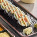 A plate of sushi rolls with Kewpie mayonnaise.