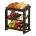 A black Cal-Mil merchandise display with three tiers of food on it.