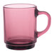 A pink glass mug with a black handle.