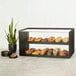 A Brooklyn 2-tier display case with pastries and a plant on a shelf.