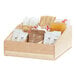 A Cal-Mil maple wooden box with a variety of condiments on a counter.