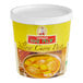 A yellow container of Mae Ploy Yellow Curry Paste with a white lid.