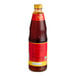 A close up of a Pantai Pad Thai Sauce bottle with a red label.