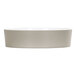 A white round melamine bowl with an oval shape inside.