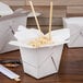 A white Fold-Pak Chinese take-out box with rice and chopsticks.