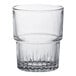 A clear Duralex glass tumbler with a white rim.