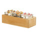A Cal-Mil oak condiment organizer with square glass jars filled with different candies.