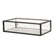 A black metal Cal-Mil bakery display case on a glass table.