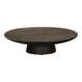 A round wooden table with a black Cal-Mil cake pedestal on top.
