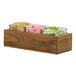 A Cal-Mil walnut condiment organizer on a counter with square glass jars inside.