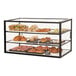 A Cal-Mil black metal 3-tier bakery display case with various pastries displayed.
