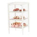 A white Cal-Mil bakery display case with glass shelves holding pastries and cupcakes.
