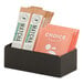 A black Cal-Mil metal condiment display tray holding matcha tea packets.
