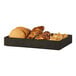 A black Brooklyn tray of cookies, bread, and other snacks on a table.
