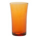 A Duralex glass with an orange rim filled with orange liquid.