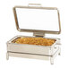 A stainless steel chafer filled with food on a counter.