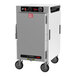 A large silver rectangular Metro heated holding cabinet with wheels and a solid door.