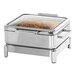A stainless steel chafer on a stand with food inside.