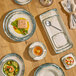 An oval gray porcelain platter with a speckled design, shown as part of a table setting.