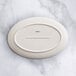 An Acopa Cape gray porcelain oval platter on a marble surface.
