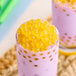 A spoon full of yellow Fanale Mango Popping Boba.