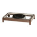 A black plate with a triangle on it in a wood chafer stand.