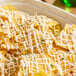 A bowl of nachos with Gehl's Queso Blanco cheese sauce.