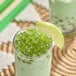 A close up of green apple flavored Bossen Pure25 Bursting Boba.