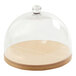 A glass dome on a wooden tray with a wooden base.