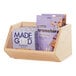A wooden counter merchandising bin filled with granola bars and a package of cereal.