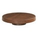 A Cal-Mil round walnut melamine cake pedestal on a wooden table.