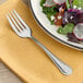 A plate of salad with an Acopa Edgeworth stainless steel salad fork.