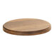 A Cal-Mil round walnut serving display stand on a wood table.
