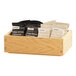 A wooden BOX WD 6.5X10X3 OAK SYDNEY on a counter with coffee and tea bags inside.