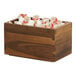 A wooden box filled with coffee yogurt on a hotel counter.