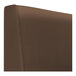 A brown leather curved corner booth with a plain back.